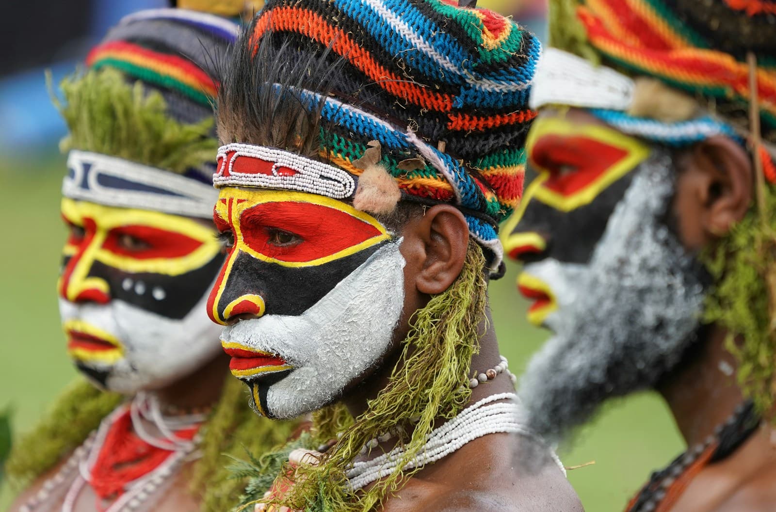 Papua New Guinea sing-sing performers in bright traditional face paint and woven headdresses at a cultural festival