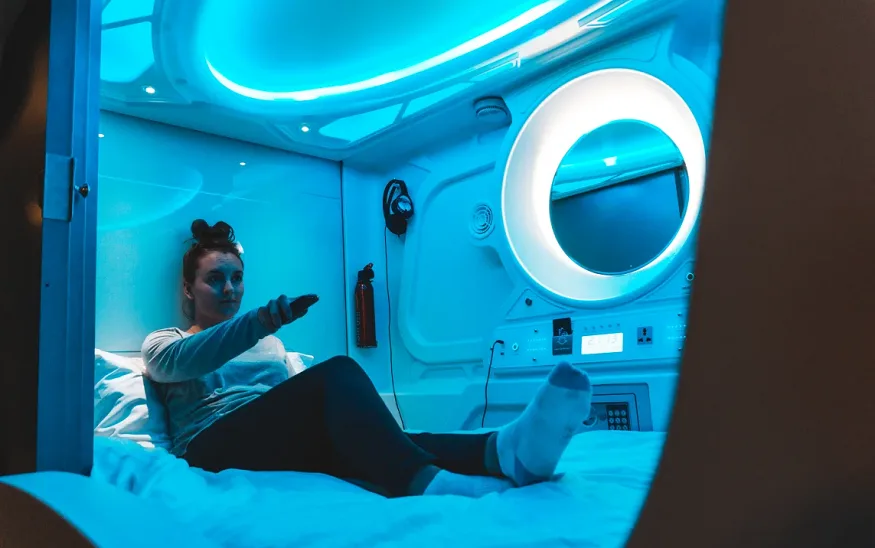 Traveller in a Hostel Galaxy Pod | BudgetBro