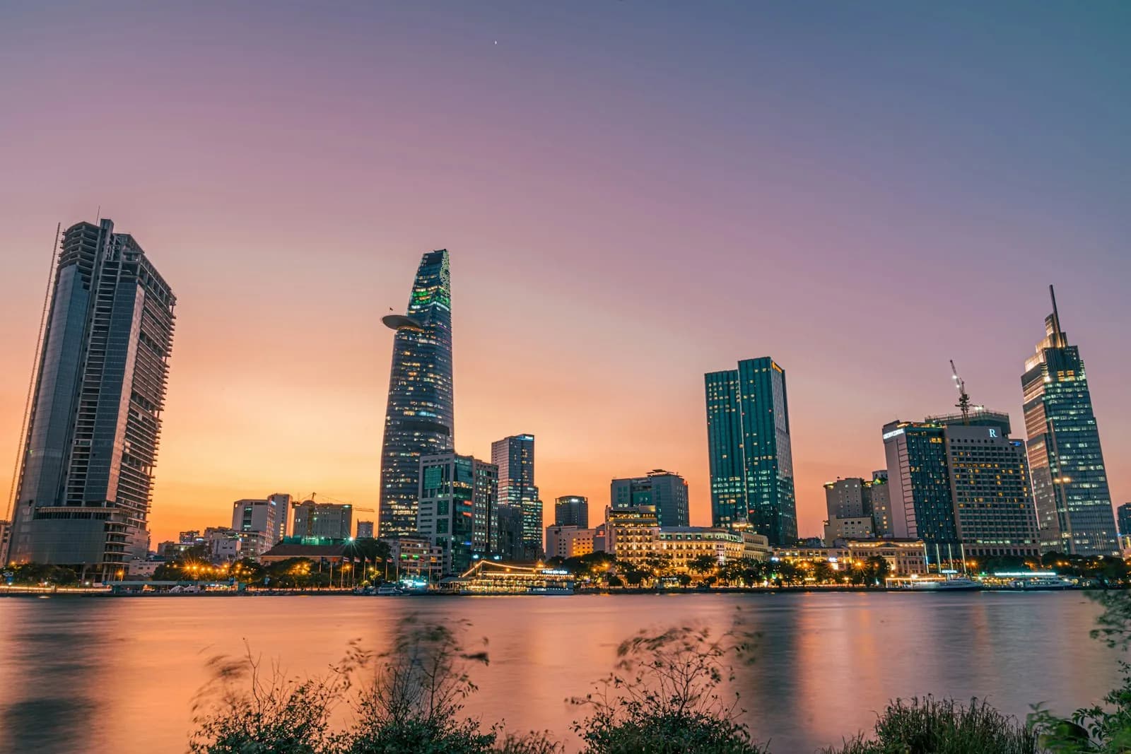 The Ho Chi Minh City skyline at sunset over the Saigon River, a major arrival point for travellers entering Vietnam | BudgetBro