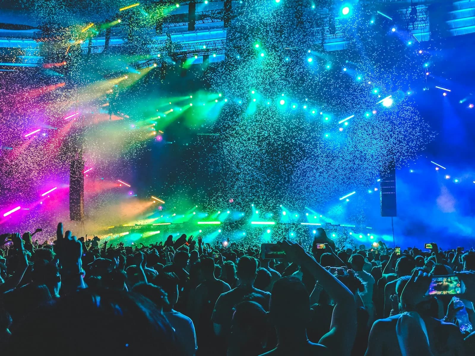 A packed arena lit with coloured lights and confetti during a live music show, the atmosphere Eurovision brings to its host city | BudgetBro