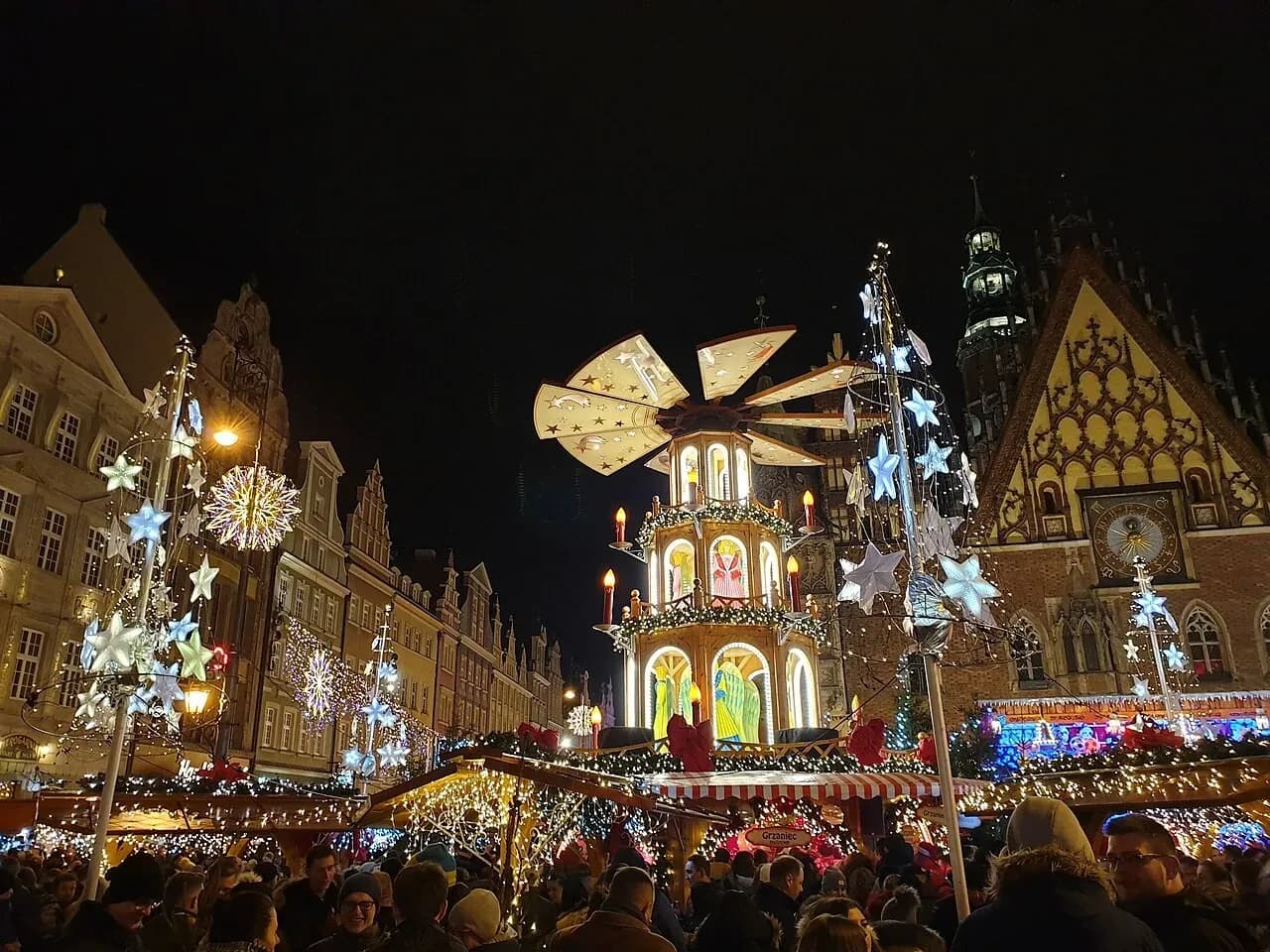 Christmas pyramid and stalls at the Wrocław Christmas market on the Rynek at night | BudgetBro