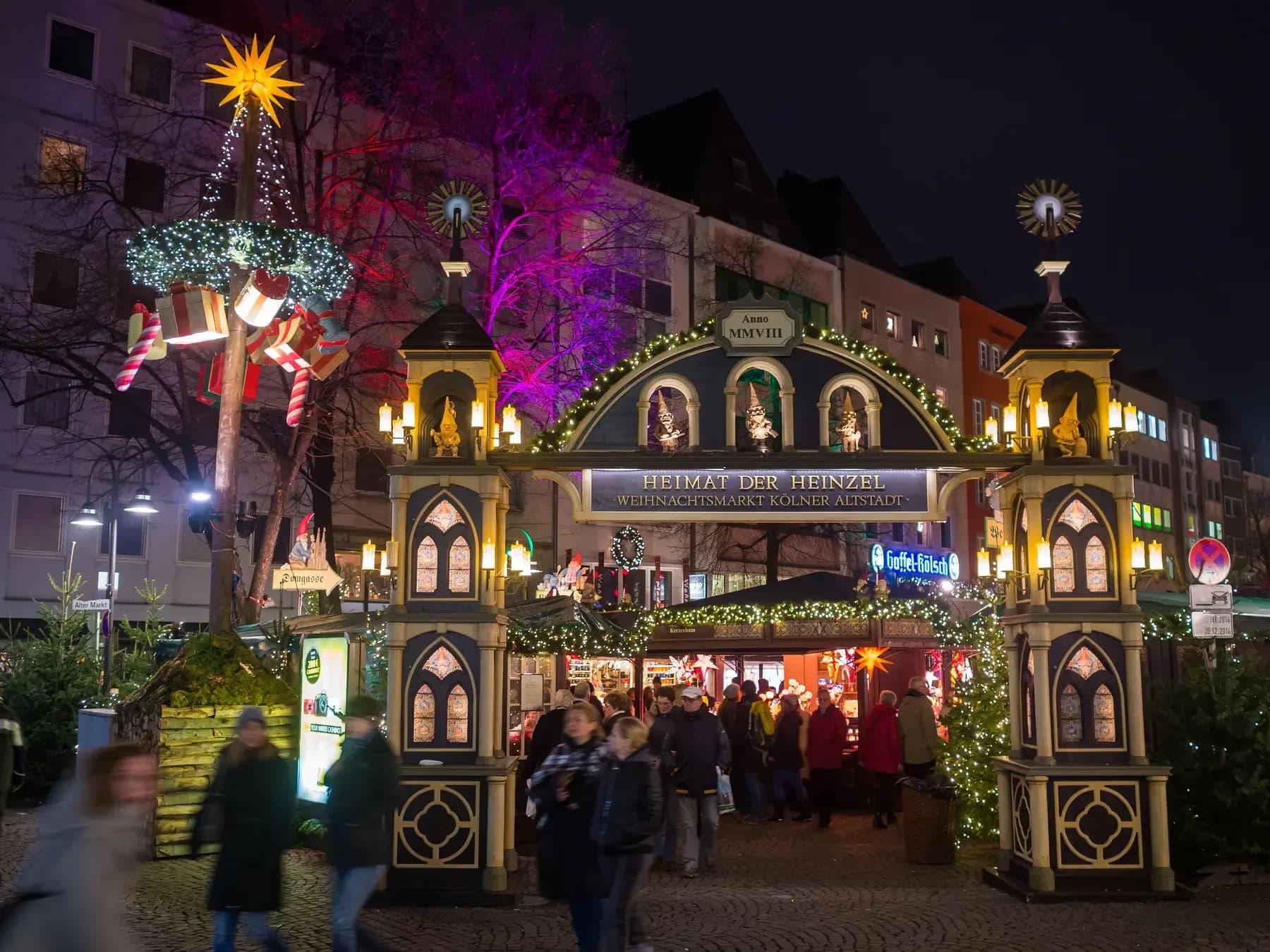 Entrance to the Heinzels Wintermärchen Christmas market in Cologne lit up at night | BudgetBro