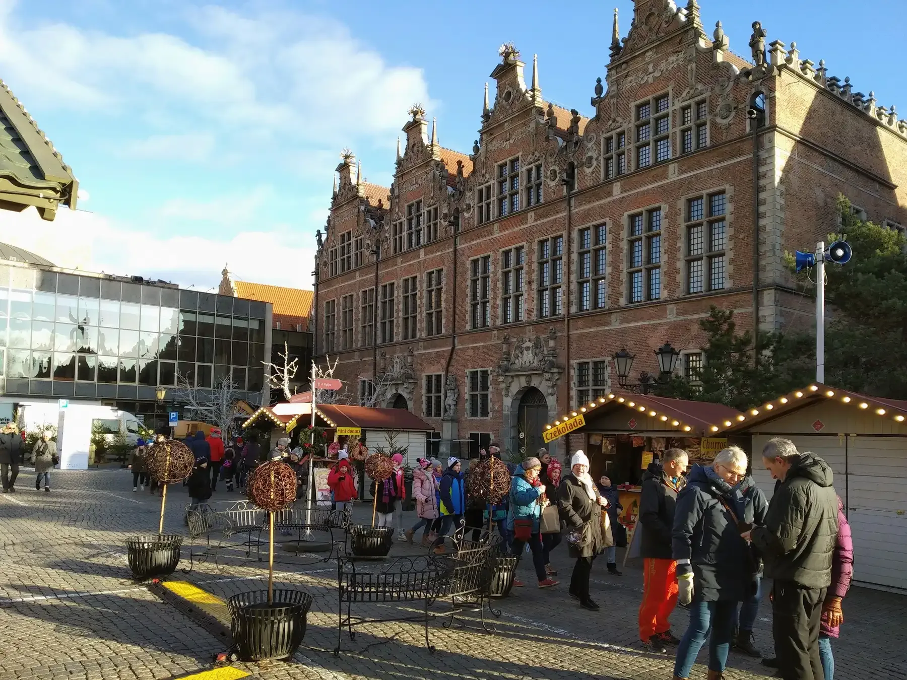 Gdańsk Christmas market stalls in winter sun in front of the Great Armoury | BudgetBro