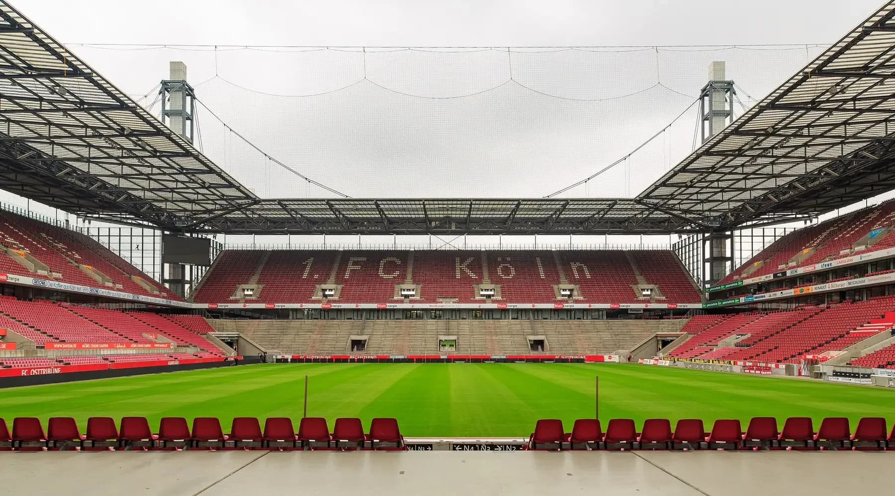 Inside RheinEnergieStadion, home of 1. FC Köln, with red seats round the pitch | BudgetBro