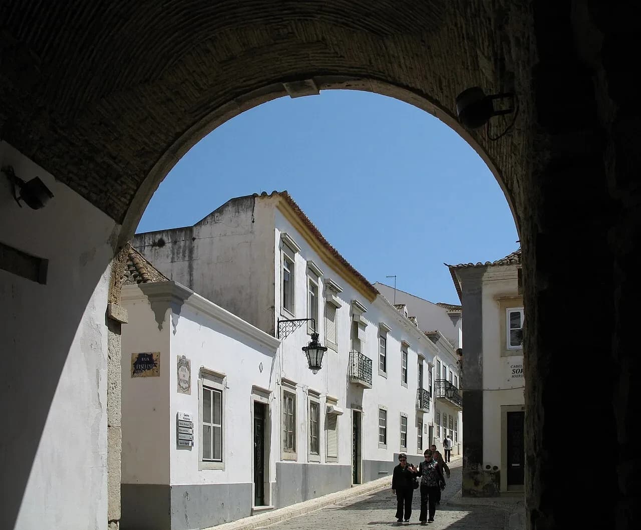 Looking through a stone arch into Faro's old town | BudgetBro