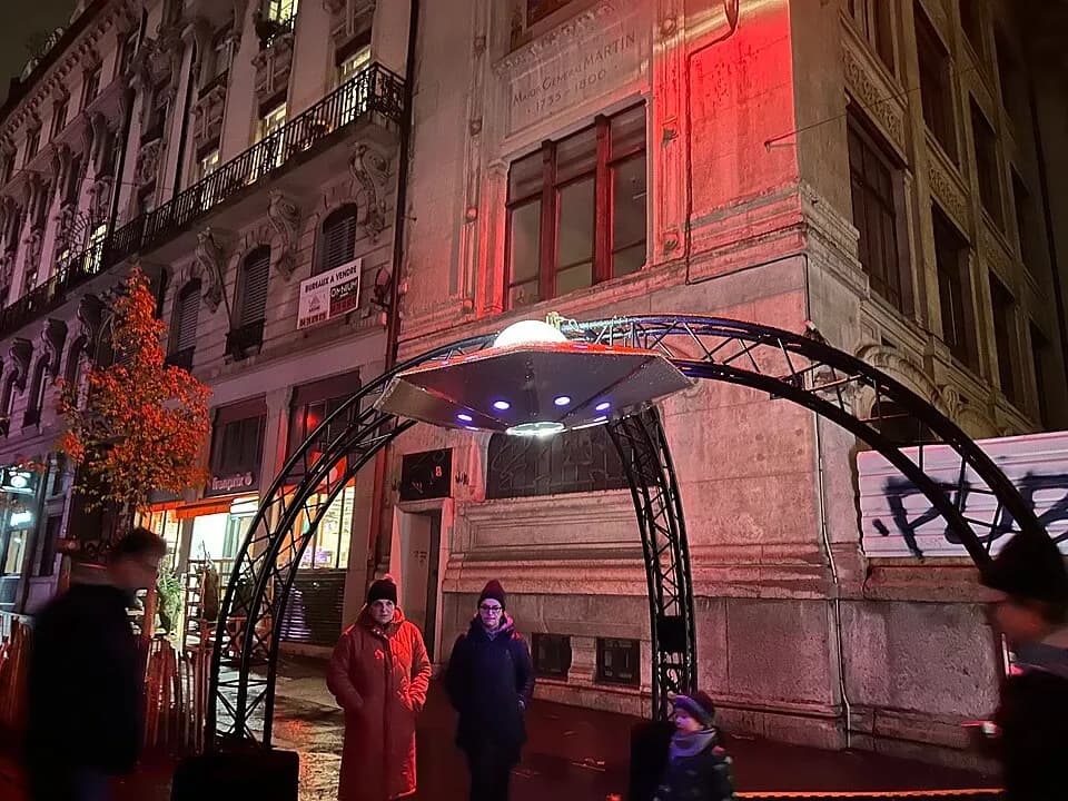 People walking through a light installation in a Lyon street during the Fête des Lumières | BudgetBro