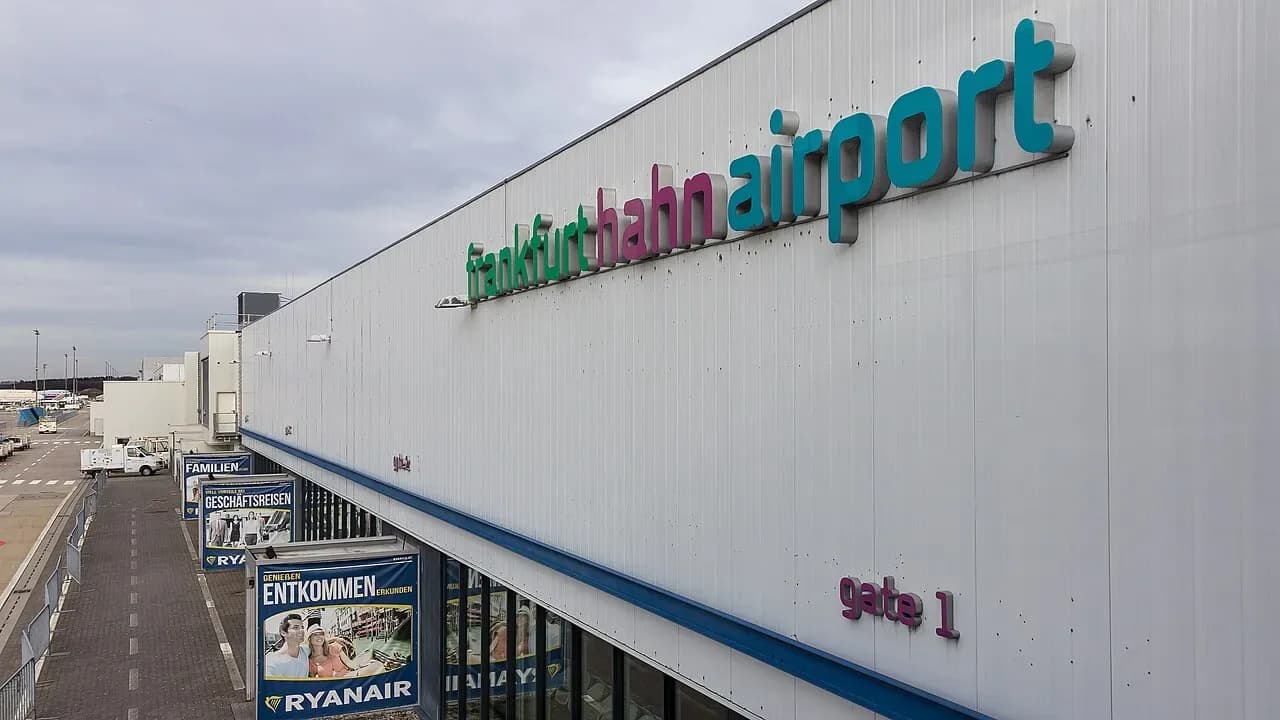 The Frankfurt-Hahn airport sign on the terminal building, with Ryanair signs below | BudgetBro