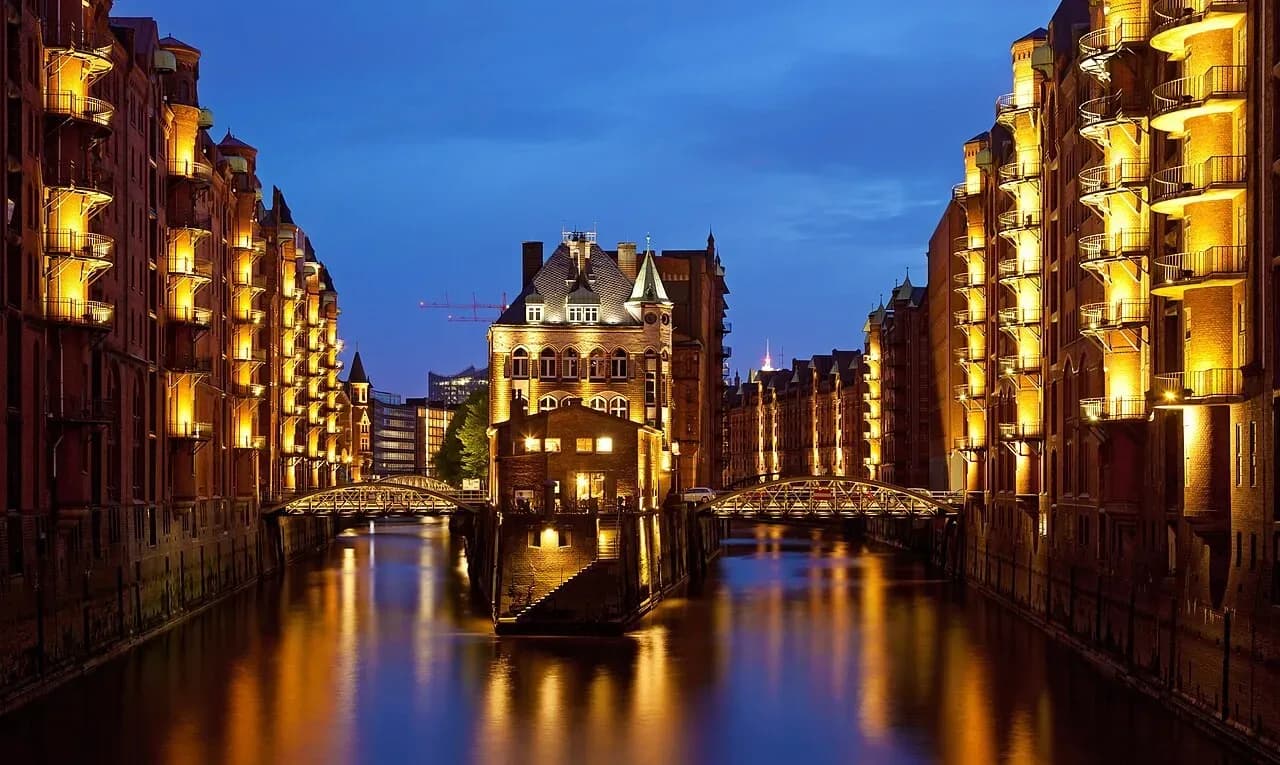 The Speicherstadt warehouse district in Hamburg lit up at dusk | BudgetBro